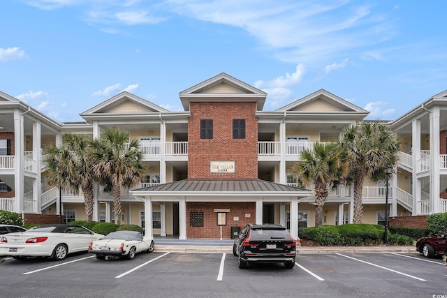 view of building exterior with uncovered parking