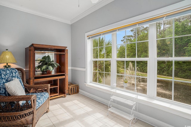 sitting room featuring ornamental molding, light tile patterned floors, a ceiling fan, and baseboards