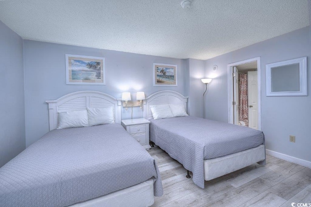 210 75th Ave N Unit 4042, Myrtle Beach, SC 29572 - bedroom with light wood finished floors and a textured ceiling