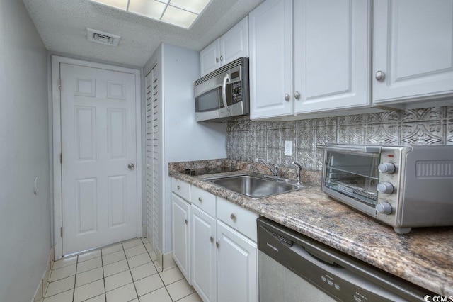 210 75th Ave N Unit 4042, Myrtle Beach, SC 29572 - kitchen with appliances with stainless steel finishes, a sink, and white cabinets