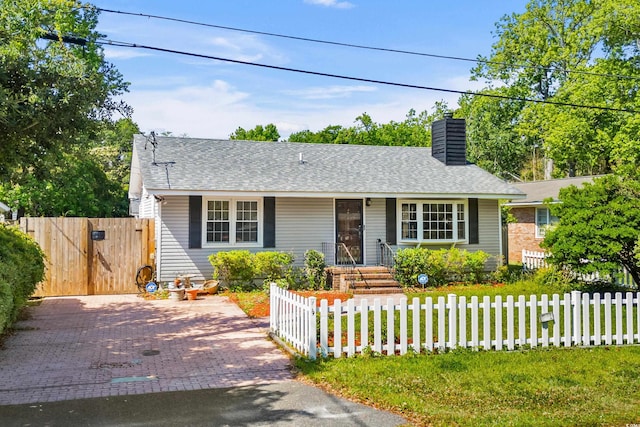 719 Juniper Dr, Myrtle Beach, SC 29575 - view of front facade with a chimney, a fenced front yard, a gate, and roof with shingles