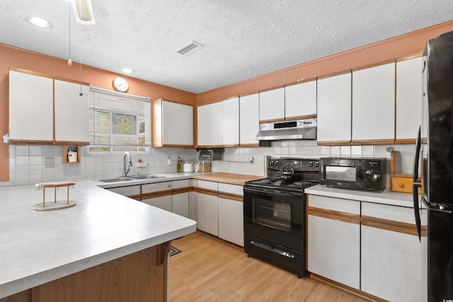 719 Juniper Dr, Myrtle Beach, SC 29575 - kitchen with black appliances, a sink, under cabinet range hood, light countertops, and a textured ceiling