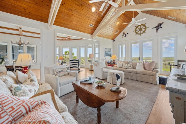 living room with a ceiling fan, wood finished floors, a chandelier, high vaulted ceiling, and beam ceiling