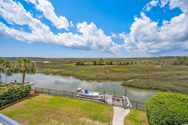 water view featuring fence and a boat dock