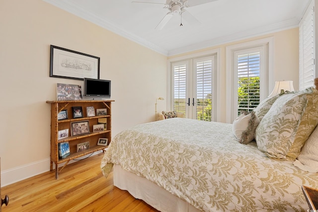 bedroom with light wood-style floors, access to exterior, crown molding, baseboards, and french doors