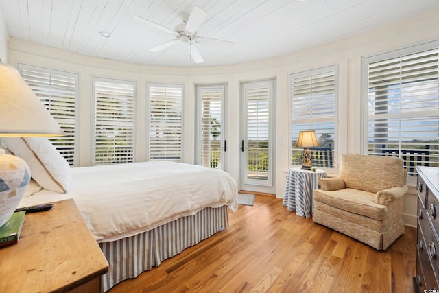 bedroom featuring access to outside, light wood finished floors, a ceiling fan, and wood ceiling