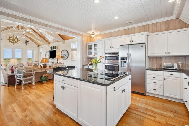 kitchen featuring appliances with stainless steel finishes, a kitchen island, wooden ceiling, white cabinets, and vaulted ceiling