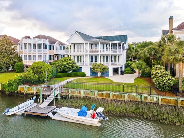dock area with a balcony and a water view