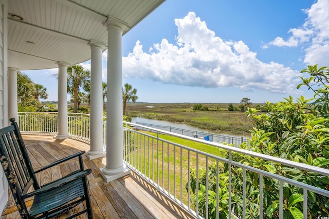 balcony with a water view and a porch