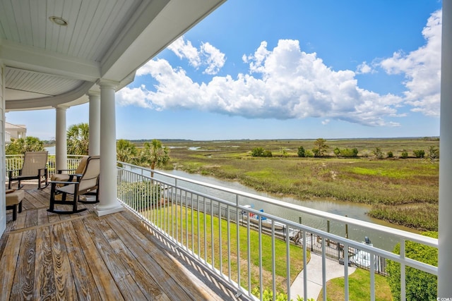 wooden terrace featuring a water view