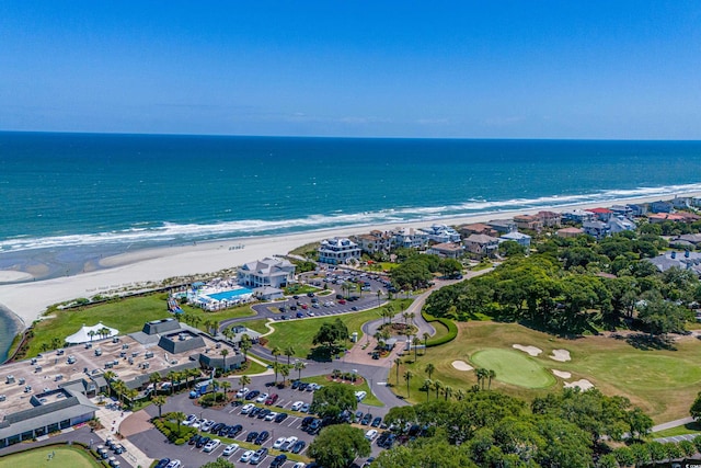 aerial view of property's location featuring waterfront with a beach