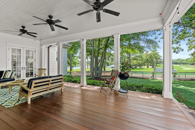 deck with french doors, a ceiling fan, and view of golf course