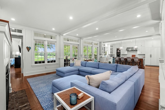 living area featuring ornamental molding, dark wood finished floors, recessed lighting, and french doors
