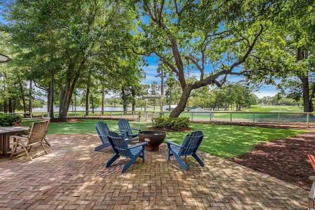 view of patio / terrace featuring a fire pit and a water view