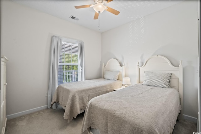 carpeted bedroom with baseboards and ceiling fan