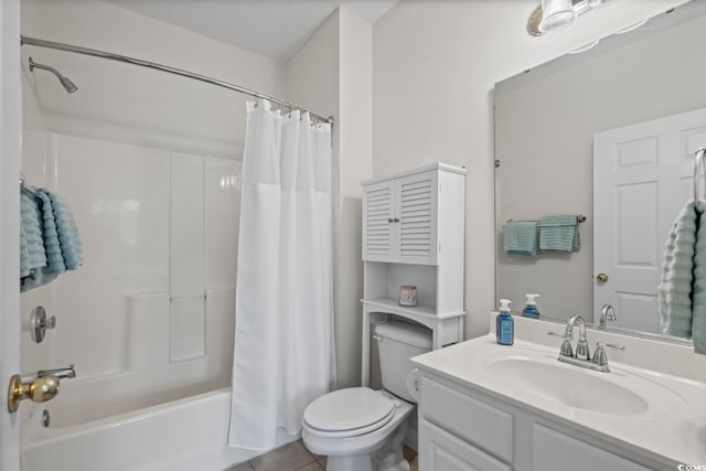 bathroom with toilet, vanity, shower / bath combo with shower curtain, and tile patterned flooring
