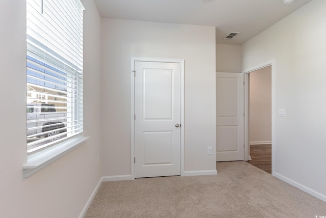 unfurnished bedroom with carpet and baseboards