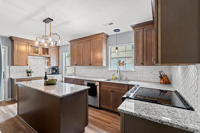 480 Dandelion Ln, Myrtle Beach, SC 29579 - kitchen with dishwasher, a sink, backsplash, and light wood-type flooring