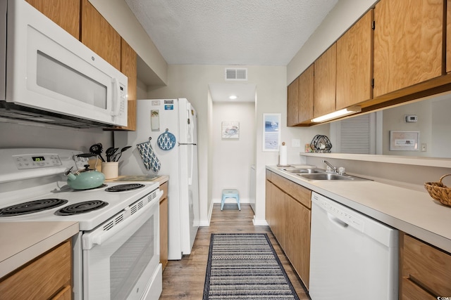 9661 Shore Dr Unit B-3, Myrtle Beach, SC 29572 - kitchen featuring white appliances, a sink, light countertops, light wood-type flooring, and a textured ceiling