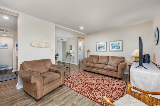 9661 Shore Dr Unit B-3, Myrtle Beach, SC 29572 - living room with wood finished floors, recessed lighting, baseboards, and a textured ceiling