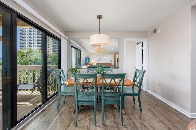 9661 Shore Dr Unit B-3, Myrtle Beach, SC 29572 - dining area with wood finished floors and baseboards