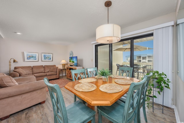 9661 Shore Dr Unit B-3, Myrtle Beach, SC 29572 - dining space with wood finished floors and a textured ceiling