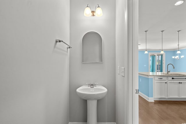 1808 Zodiac Ct, Myrtle Beach, SC 29577 - bathroom with a sink, wood finished floors, a chandelier, and baseboards