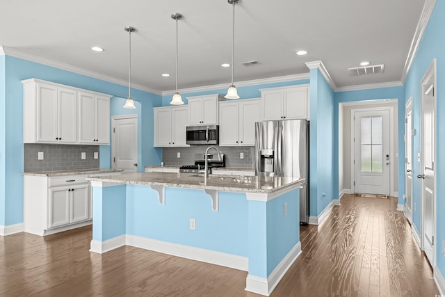 1808 Zodiac Ct, Myrtle Beach, SC 29577 - kitchen with appliances with stainless steel finishes, dark wood-style flooring, an island with sink, decorative backsplash, and recessed lighting