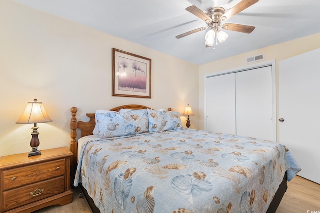 7509 N Ocean Blvd Unit 404, Myrtle Beach, SC 29572 - bedroom with light wood finished floors, a closet, and ceiling fan