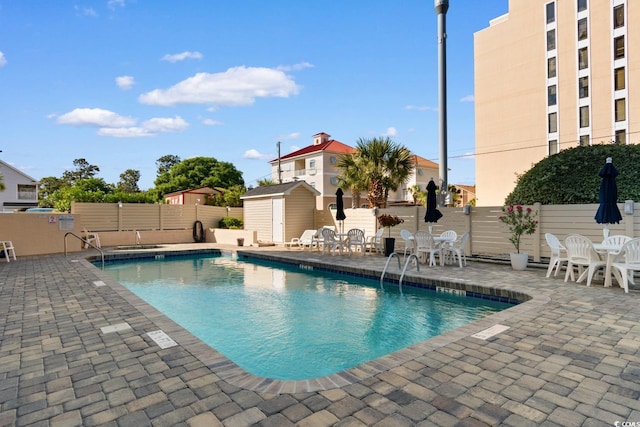 7509 N Ocean Blvd Unit 404, Myrtle Beach, SC 29572 - community pool with a patio area, a storage shed, an outbuilding, and fence