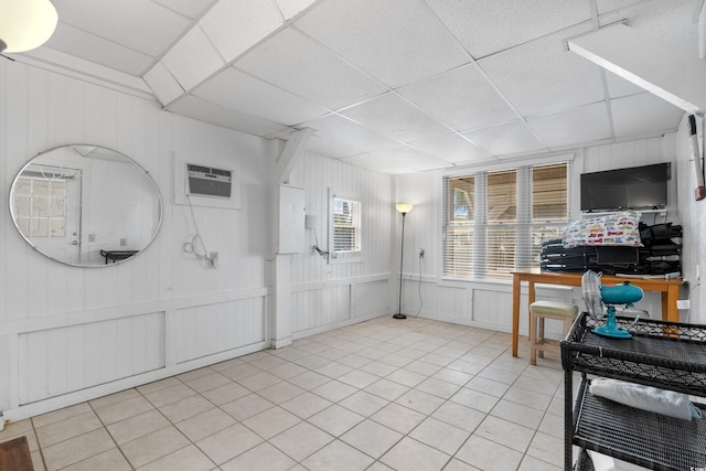 337 59th Ave N, North Myrtle Beach, SC 29582 - kitchen with a wall unit AC, a paneled ceiling, a decorative wall, and light tile patterned floors