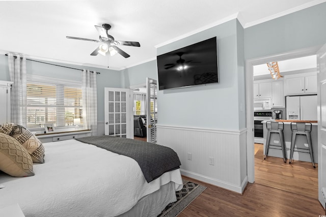 337 59th Ave N, North Myrtle Beach, SC 29582 - bedroom featuring ornamental molding, white fridge with ice dispenser, a wainscoted wall, wood finished floors, and multiple windows