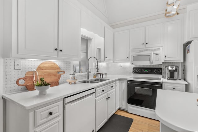 337 59th Ave N, North Myrtle Beach, SC 29582 - kitchen featuring white appliances, a sink, white cabinets, light countertops, and backsplash