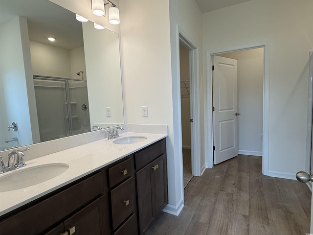 1029 Jase Dr, Longs, SC 29568 - full bath with a stall shower, double vanity, wood finished floors, a spacious closet, and baseboards