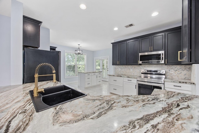854 Falkirk St, Myrtle Beach, SC 29579 - kitchen with appliances with stainless steel finishes, a sink, backsplash, light stone counters, and recessed lighting