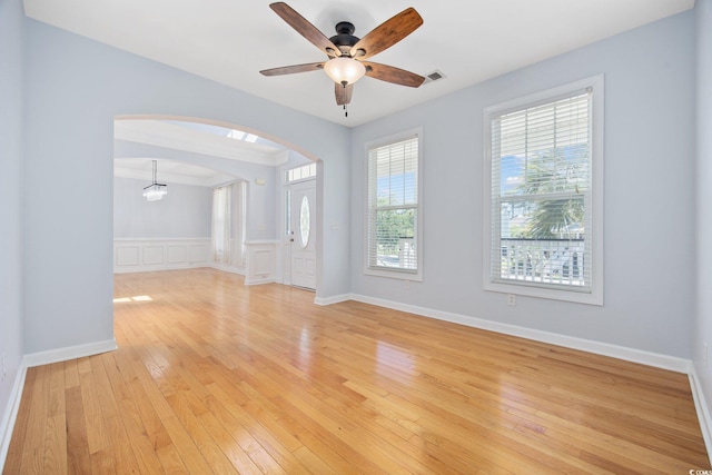 854 Falkirk St, Myrtle Beach, SC 29579 - spare room with light wood-style floors, arched walkways, and a ceiling fan