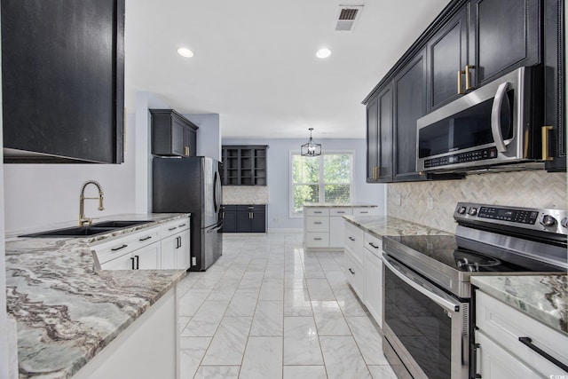 854 Falkirk St, Myrtle Beach, SC 29579 - kitchen featuring appliances with stainless steel finishes, a sink, tasteful backsplash, light marble finish flooring, and light stone countertops
