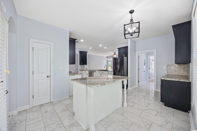 854 Falkirk St, Myrtle Beach, SC 29579 - kitchen featuring appliances with stainless steel finishes, light marble finish floors, dark cabinets, light stone countertops, and baseboards
