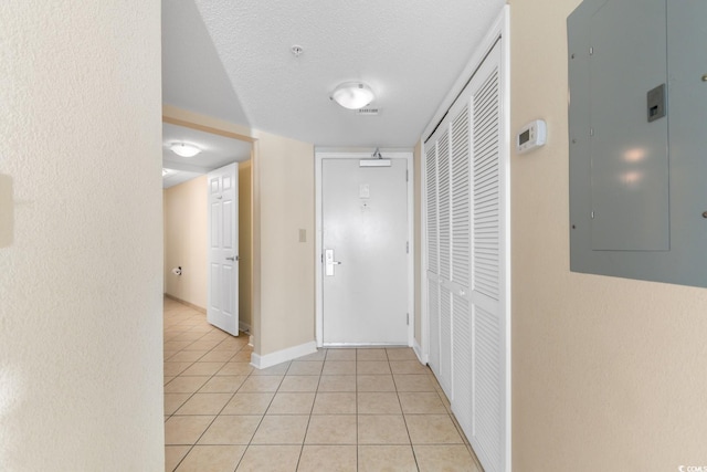 2501 S Ocean Blvd Unit 831, Myrtle Beach, SC 29577 - corridor with electric panel, light tile patterned flooring, baseboards, and a textured ceiling