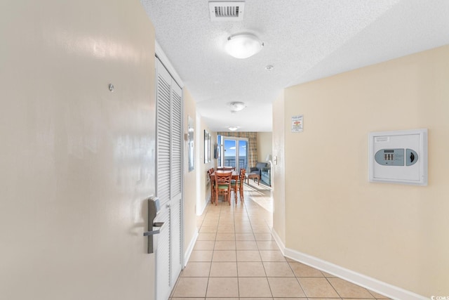 2501 S Ocean Blvd Unit 831, Myrtle Beach, SC 29577 - corridor featuring light tile patterned flooring, a textured ceiling, and baseboards