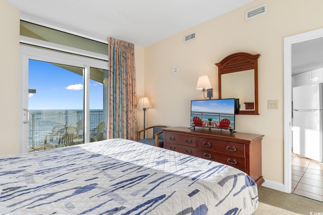 2501 S Ocean Blvd Unit 831, Myrtle Beach, SC 29577 - carpeted bedroom with freestanding refrigerator, access to exterior, and baseboards