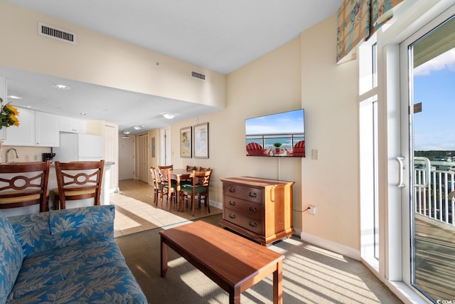2501 S Ocean Blvd Unit 831, Myrtle Beach, SC 29577 - living room featuring healthy amount of natural light, light carpet, and baseboards