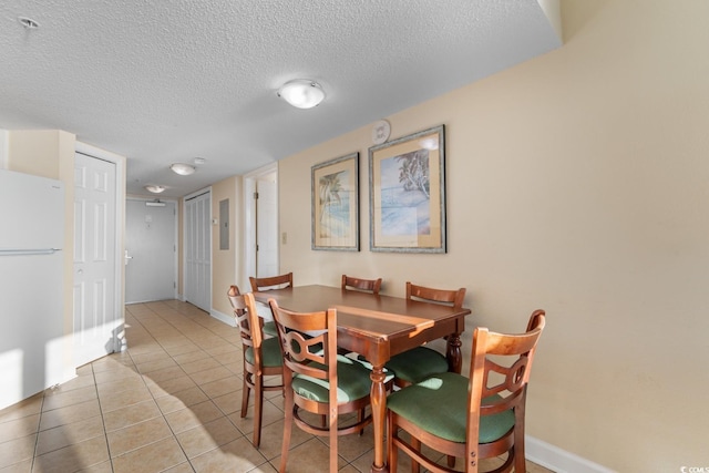2501 S Ocean Blvd Unit 831, Myrtle Beach, SC 29577 - dining area featuring a textured ceiling, light tile patterned floors, and baseboards