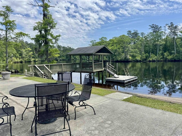 view of patio / terrace featuring a water view and a floating dock