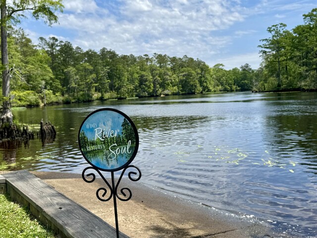 dock featuring a water view and a wooded view