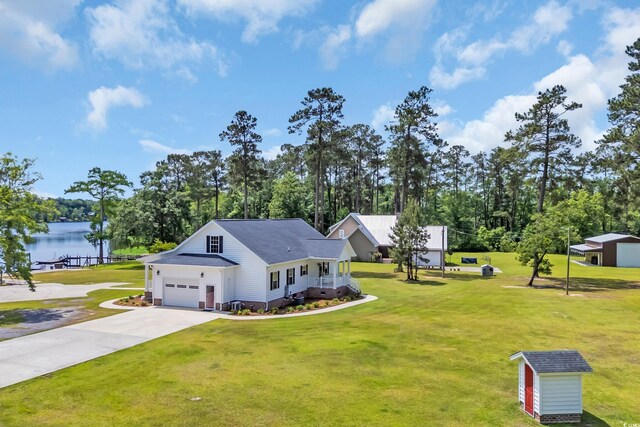 view of side of property featuring a lawn, a storage shed, and concrete driveway