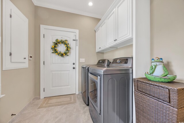 laundry room featuring washing machine and dryer, cabinet space, baseboards, and light marble finish flooring