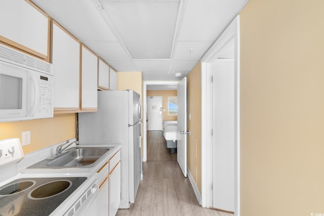 2000 Ocean Blvd N Unit Ph11, Myrtle Beach, SC 29577 - kitchen featuring white appliances, light wood-type flooring, a sink, light countertops, and white cabinetry