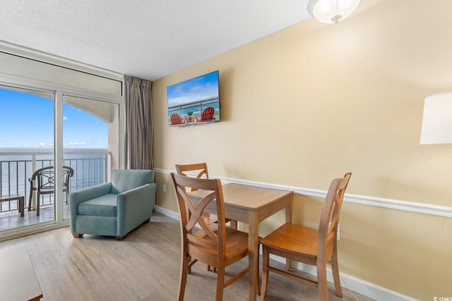 2000 Ocean Blvd N Unit Ph11, Myrtle Beach, SC 29577 - dining space featuring wood finished floors, baseboards, and a water view