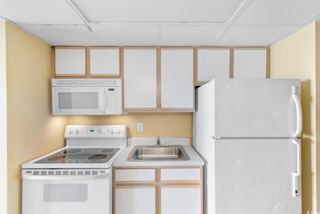 2000 Ocean Blvd N Unit Ph11, Myrtle Beach, SC 29577 - kitchen with white appliances, a sink, light countertops, a paneled ceiling, and white cabinets